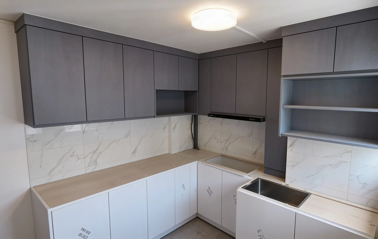L-shaped kitchen with grey upper cabinets in a 3-room HDB flat in Punggol